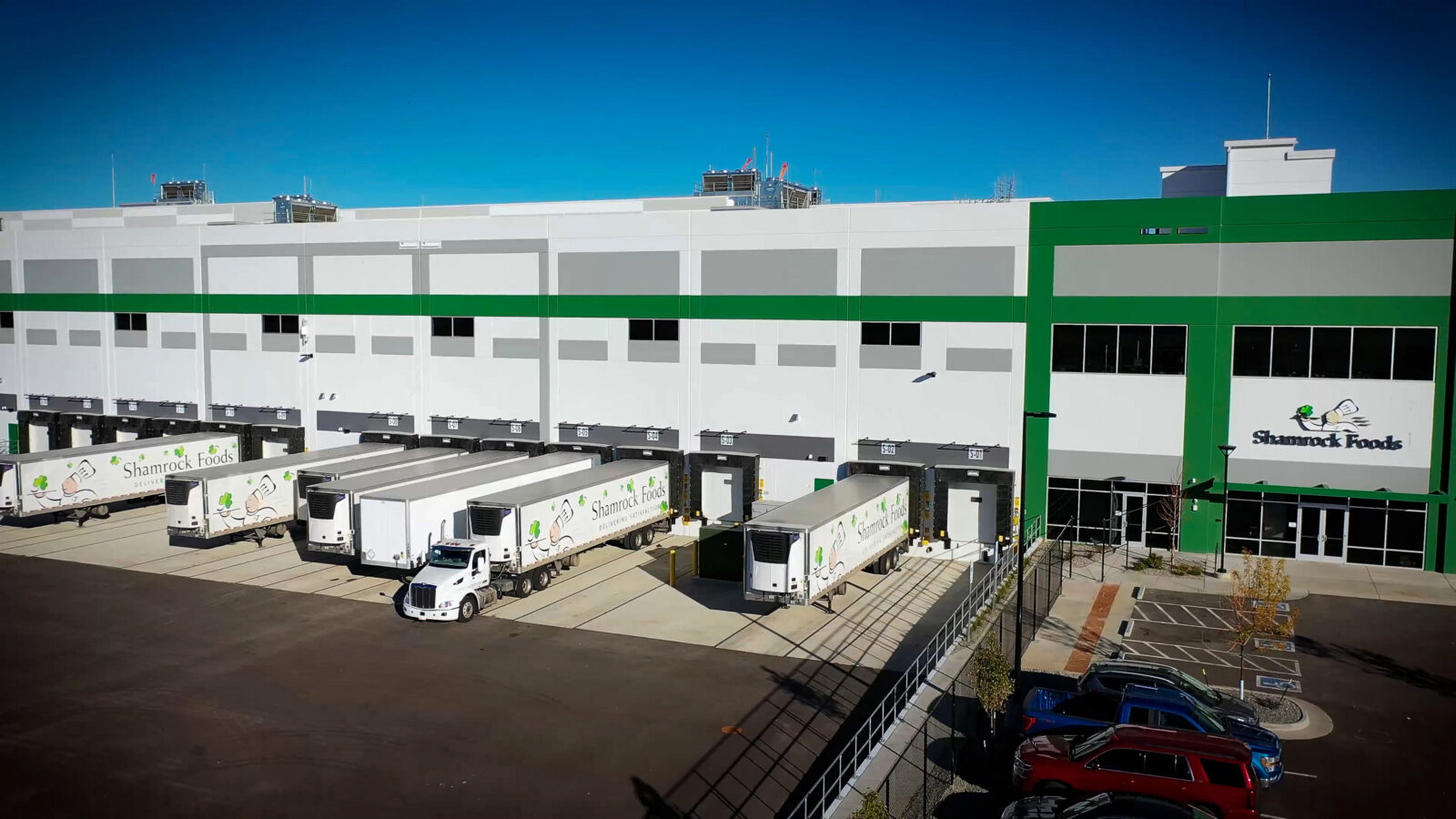 A Shamrock Foods warehouse exterior with several tractor trailers.